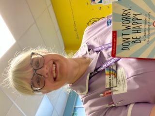 Colleague holding a mental health book.