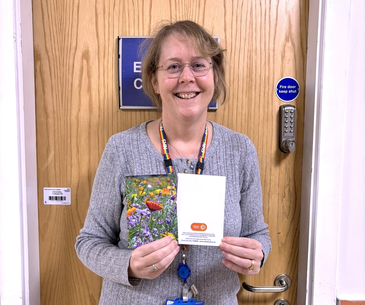 Bereavement lead holding bereavement cards that are sent out to family members. 